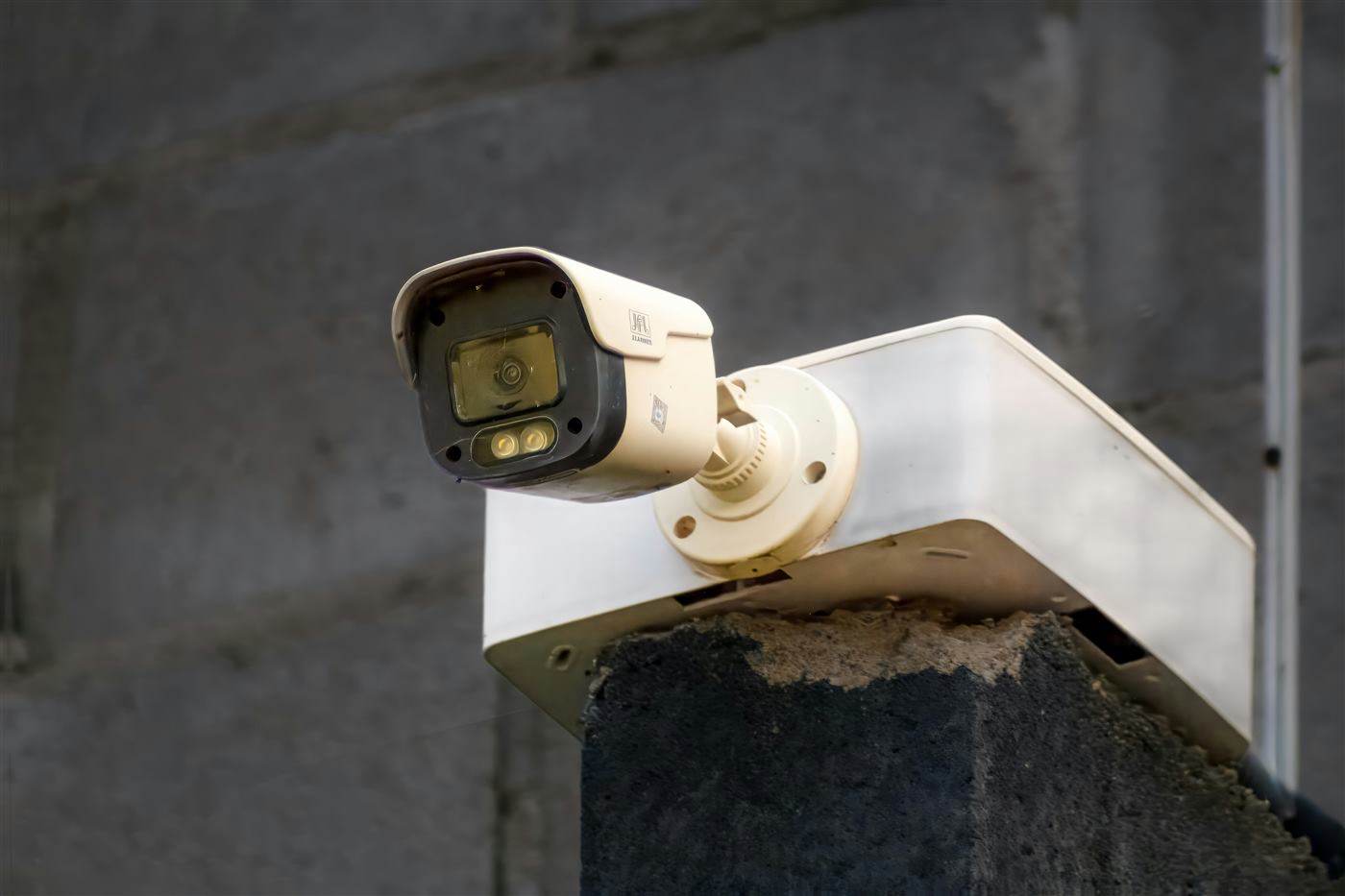 Wall-mounted outdoor CCTV camera installed above an entry point.